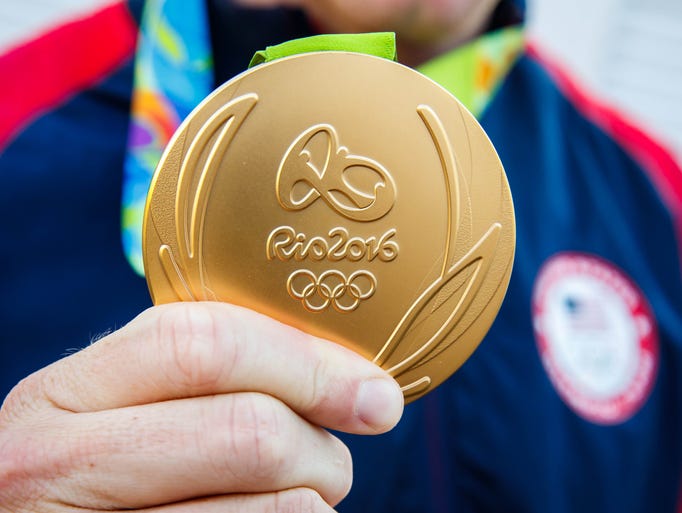 The most medals. Олимпийские медали. Олимпийское золото. Золотая медаль. Олимпийская медаль борьба.