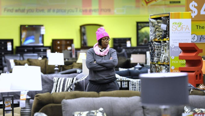 Cheryl Carter of Detroit looks for a couch at the Art Van on 14 Mile in Warren. The chain is set to be sold to Thomas H. Lee Partners.
