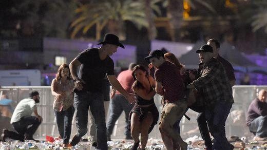 People carry a person at the Route 91 Harvest country music festival in Las Vegas Sunday night.