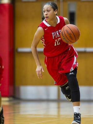Pike High School senior Alyssa Clay (12) brings the ball up court after a rebound during first half action. Roncalli High School hosted Pike High School in girls' varsity basketball action, Saturday, Nov. 15, 2014.