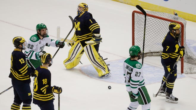 Michigan goalie Steve Racine reacts after giving up a goal to North Dakota's Luke Johnson (27) during the second period of U-M's 5-2 loss in the Midwest Region final Saturday in Cincinnati.