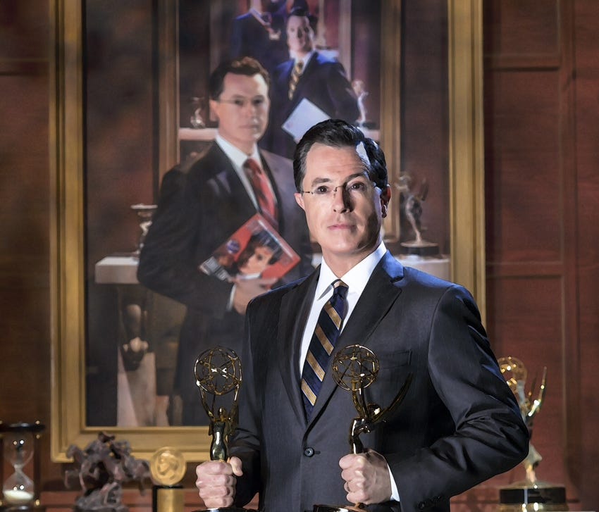 This handout photo provided by the Smithsonian shows Stephen Colbert poising in front of his portrait.