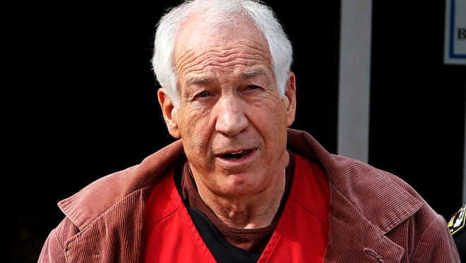 In this Oct. 29, 2015 file photo, former Penn State University assistant football coach Jerry Sandusky leaves the Centre County Courthouse after attending a hearing about his appeal in Bellefonte, Pa. The state must restore the pension of Sandusky that was taken away three years ago on the day he was sentenced to prison on child molestation convictions, a court ordered Friday.