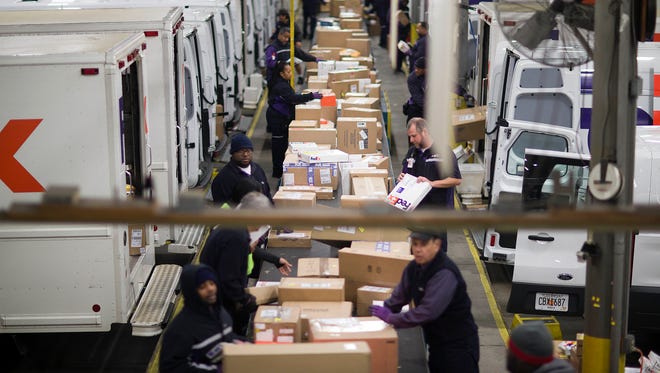 Packages are sorted on a conveyer belt before being loaded onto trucks for delivery at a FedEx facility in Marietta, Ga.