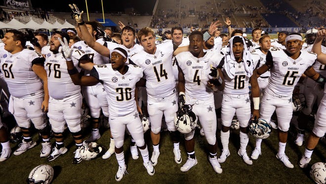 Vanderbilt players, including quarterback Kyle Shurmur (14), sing the school alma mater after defeating Middle Tennessee 28-6 in an NCAA college football game Saturday, Sept. 2, 2017, in Murfreesboro, Tenn. (AP Photo/Mark Humphrey)