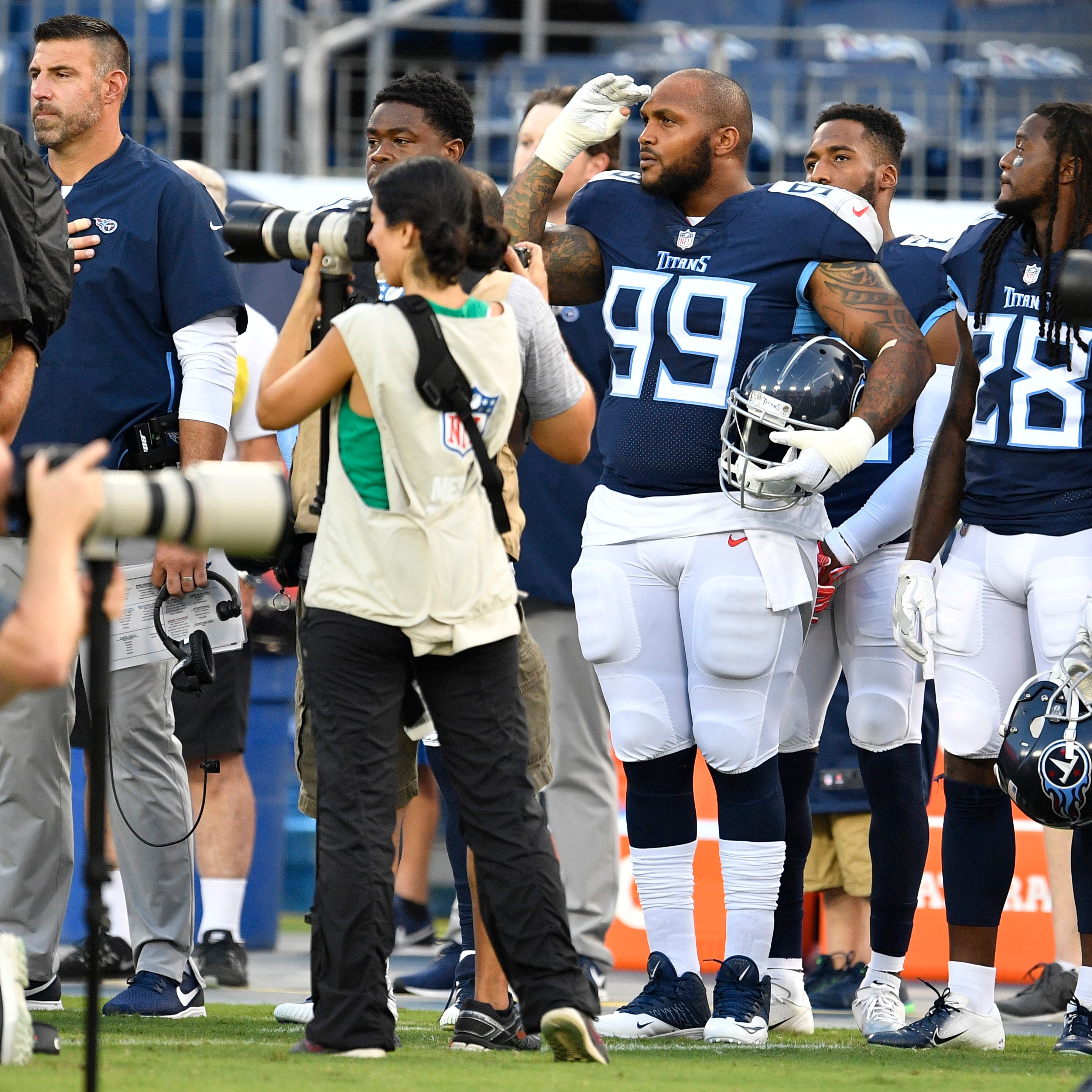 Titans defensive tackle Jurrell Casey (99) salutes during the National Anthem before the preseason game against the Tampa Bay Buccaneers at Nissan Stadium Saturday, Aug. 18, 2018, in Nashville, Tenn.