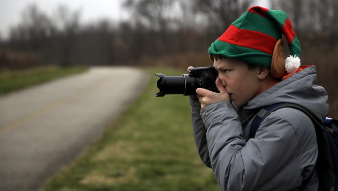 Ethan Rising takes photos of birds Saturday during the Christmas Bird Count at Woodland Mound.