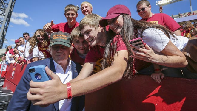 Republican presidential candidate Donald Trump greets fans on the field prior to the Iowa-Iowa State football game  Saturday Sept. 12 2015, at Jack Trice Stadium in Ames, Iowa.