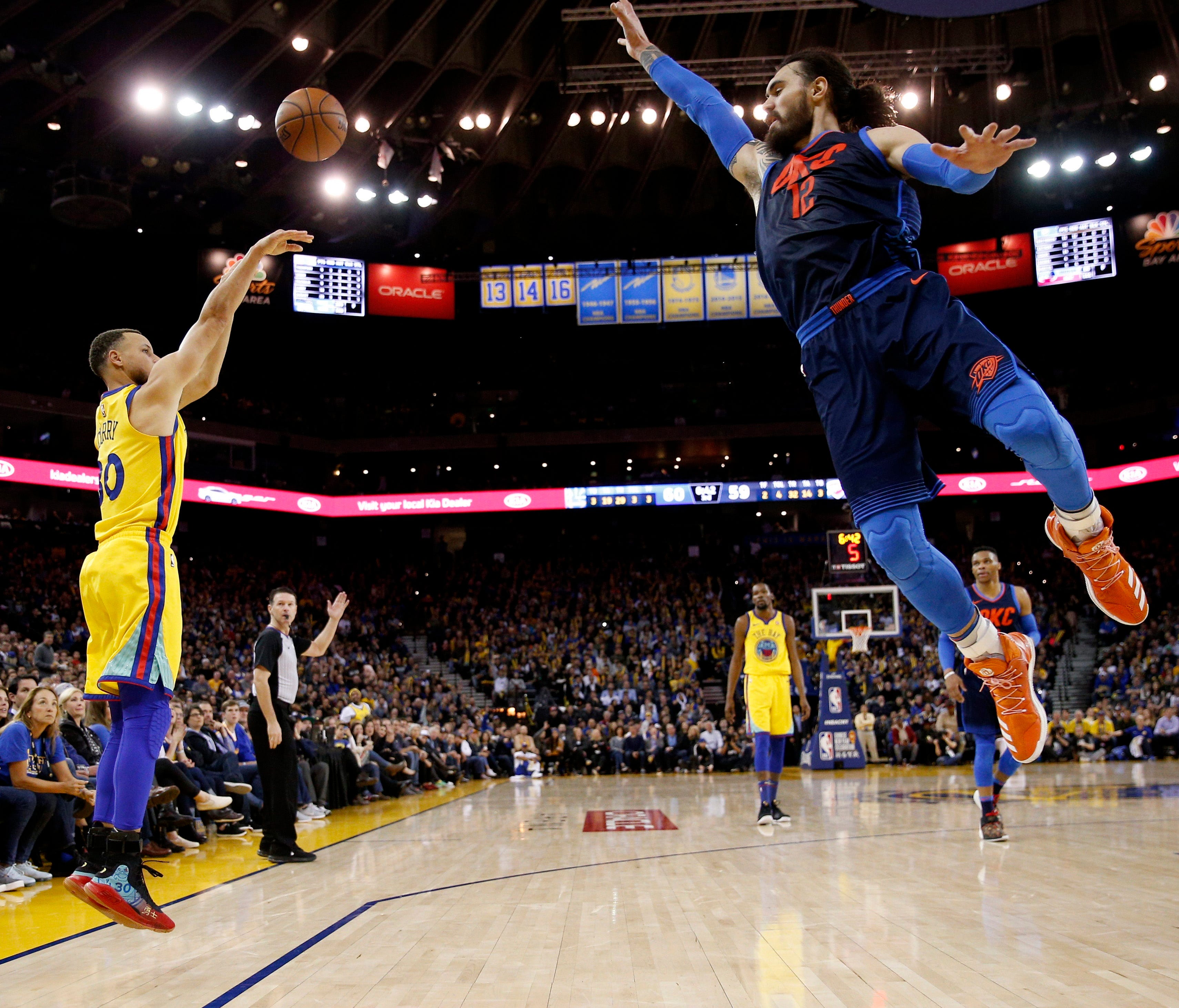Feb. 24: Warriors guard Steph Curry shoots over Thunder defender Steven Adams during the second half in Oakland.