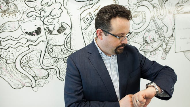 Evernote CEO Phil Libin glances at watch
