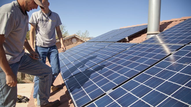 Technicians from Legend Solar install solar panels on a St. George home Friday, March 20, 2015.