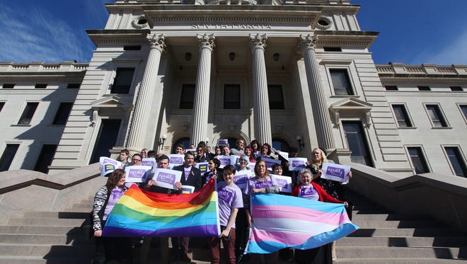 Representatives from the Center for Equality, American Civil Liberties Union of South Dakota, LGBT supporters and members of the Human Rights Campaign stand on the front steps in honor of Trans Kids Support Visibility Day at the State Capitol in Pierre on Tuesday, Feb. 23, 2016.