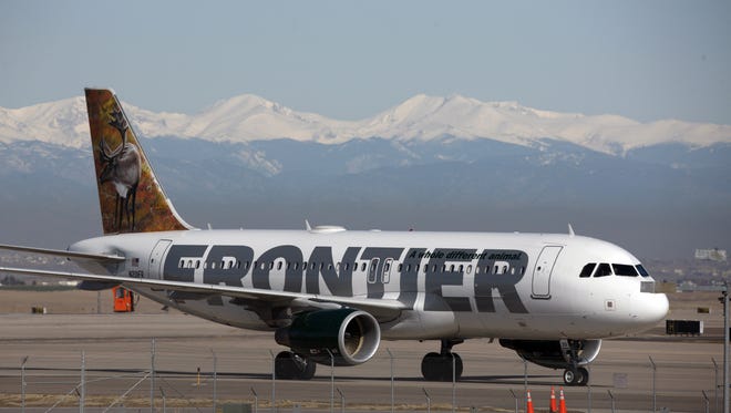 In this April 8, 2010, photo, a Frontier Airlines jetliner arrives at Denver International Airport.