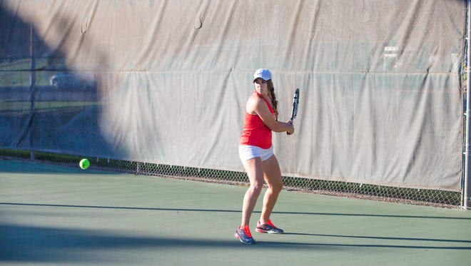 Dixie State's No. 1 singles player Lacey Hancock hits a backhand during a recent tennis practice.