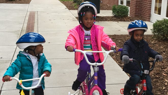 Kamry Jones, 2; Lilly Walton, 4, and LaMichael McClain, 3, after getting new biles at Family Scholar House.