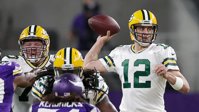 Green Bay Packers quarterback Aaron Rodgers (12) throws behind his offensive line against the Minnesota Vikings at U.S. Bank Stadium.
