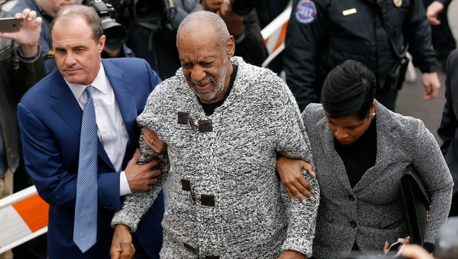 Bill Cosby, center, accompanied by his attorneys Brian McMonagle, left, and Monique Pressley, arrives at court to face a felony charge of aggravated indecent assault, in Elkins Park, Pa, on Dec. 30, 2015.
