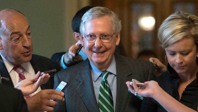Senate Majority Leader Mitch McConnell smiles as he leaves the chamber after announcing the release of the Republicans’ health care bill at the Capitol on Thursday.