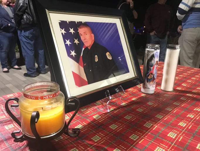Paul Lazinsky's photo is surrounded by candles at the