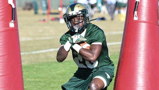 CSU running back Deron Thompson executes a drill Tuesday, March 10, 2015 at CSU's practice football fields in Fort Collins, CO.