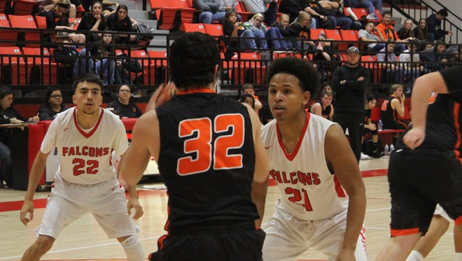Seniors Robert Franco (left) and Brandon Rainey guard a Captain Tigers player during Saturday's district game, Jan. 27, 2018.