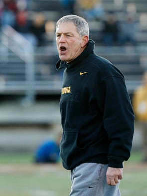 Head football coach Kirk Ferentz leads his players