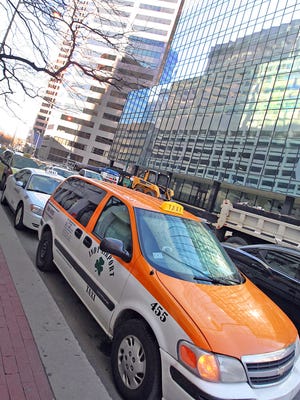 Wednesday, January 18, 2012,  Taxi cabs waiting in a queue outside the downtown hotel,  Sheraton Indianapolis, (31 West Ohio Street).  This is for an A1 Sunday story on getting around Indy during the Super Bowl: A look at whether Indy has enough cabs and public transportation to handle all the crowds. Frank Espich/The Star (sbtransport22)
