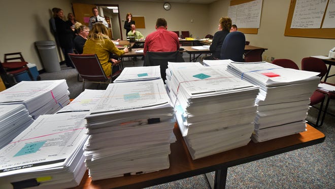 In this November 2017 photo, county employees and investigators in the Jacob Wetterling case review thousands of documents in the case file, in the Wetterling Room at the Stearns County Law Enforcement Center.