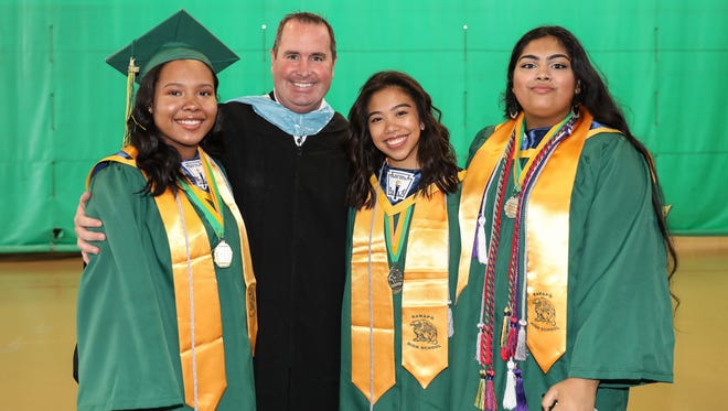 Guidance councelor Mathew Sullivan, second from left, with from left Kayle Hoke, Lauren Montoya and Jayasree Murali pose for a photo prior to Ramapo High School's graduation ceremony at Rockland Community College in Suffern on Sunday, June 24, 2018. 