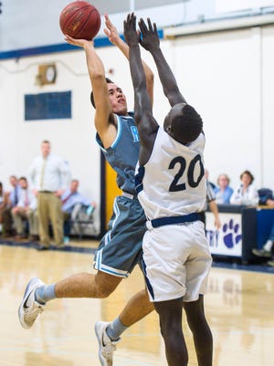 South Burlington's Ben Moran shoots during a high school boys basketball game last season.