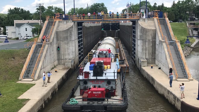 A barge carrying three 60-foot-tall fermentation tanks to the Genesee Brewery enters Lock E2 in Waterford, Saratoga County, on Friday, May 19, 2017.