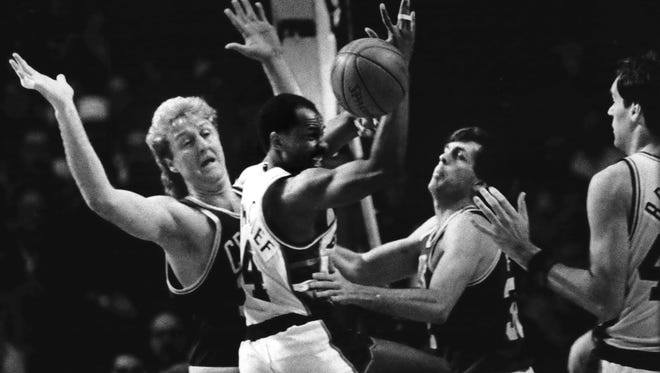 Milwaukee Bucks guard Sidney Moncrief (center) scrambled for the ball between Boston Celtics forwards Larry Bird and Kevin McHale in the NBA Conference championship playoff game at the Arena in 1986.  The Bucks lost the game, 11-98, and were eliminated in the series, 4-1.