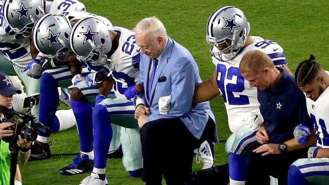 In a game last season, the Dallas Cowboys, led by owner Jerry Jones, take a knee prior to the national anthem before a game in Arizona.
