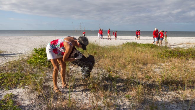 Casey Arlen, left, and her husband Len joined about 50 other volunteers to help clean Fort Myers Beach on Saturday morning for Make A Difference Day.