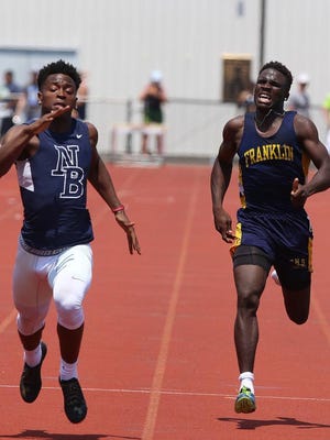 New Brunswick's Maurice Ffrench (left) and Franklin's Mario Heslop (right) battle it out in the 200 meters.