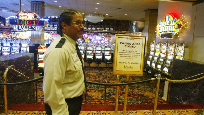 Casinos closed in Atlantic City due to the state budget impasse in July 2006. The closed casino area at Ballys where only aisles were open for people to walk thru on their way to other parts of the hotel complex but all gambling was taped off.  Bally's security guard Fred Finches stands in front of the gaming area.