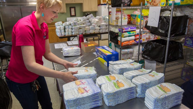 Megan Fischer, CEO of Sweet Cheeks Diaper Bank, packages diapers that will go out to14 different social service agencies and their families in need. Diapers are not covered by food stamps or WIC. The non-profit services about 900 children a month, which Fischer says barely scratches the surface. Based on census and poverty data, there's about 16,000 children experiencing diaper need, she said. 
