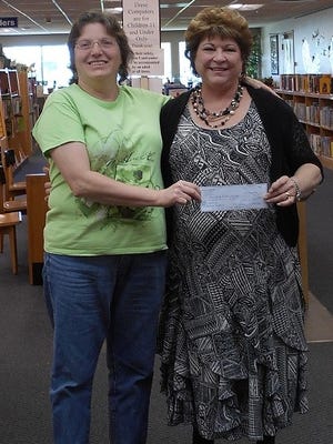 Women of the Moose donated $100 to the Alamogordo Public Library last week. Secretary and Treasure Dion Kidd (L) presents the check to Library Manager Susan Rowe (R).