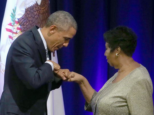 President Barack Obama fist bumps with Aretha Franklin after she sang at a farewell ceremony for Attorney General Eric Holder at the Justice Department in February 2015.