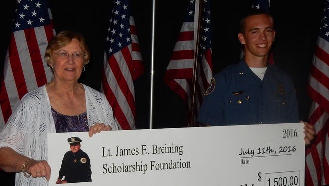 Pictured with Dennis Stack receiving his award at the National Law Enforcement Explorer
Conference is Barbara Breining, President of the Lt. James Breining Scholarship Foundation