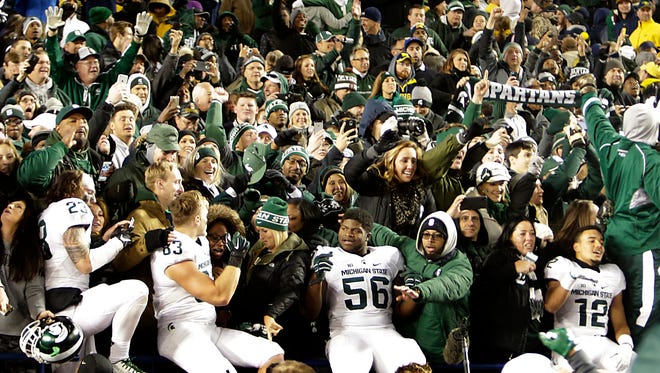 Michigan State players and fans celebrate after MSU's 27-23 win over Michigan on the game's final play Oct. 17, 2015 in Ann Arbor.
