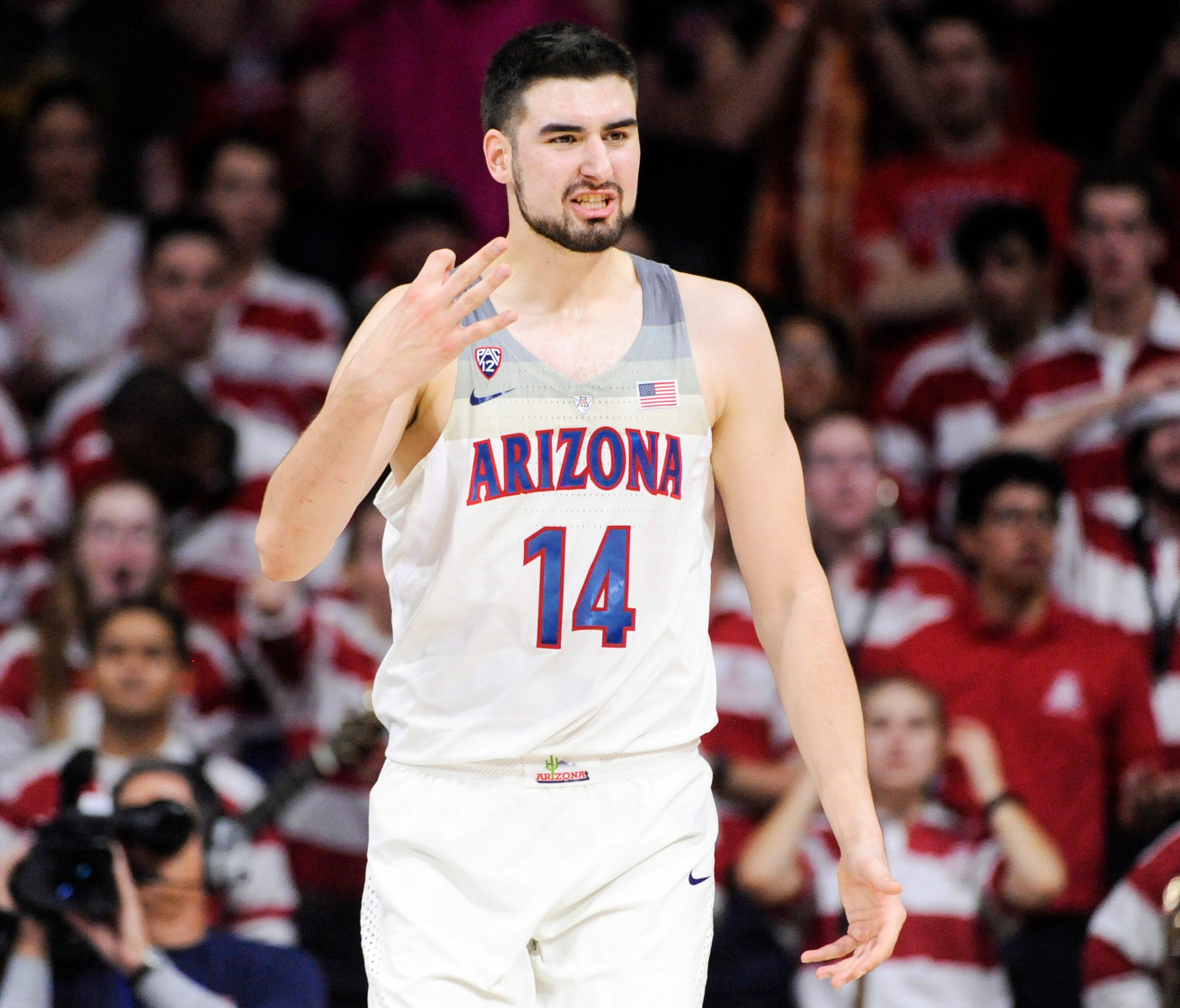 Arizona center Dusan Ristic signals to the bench after he is called for a foul during the second half against Utah.