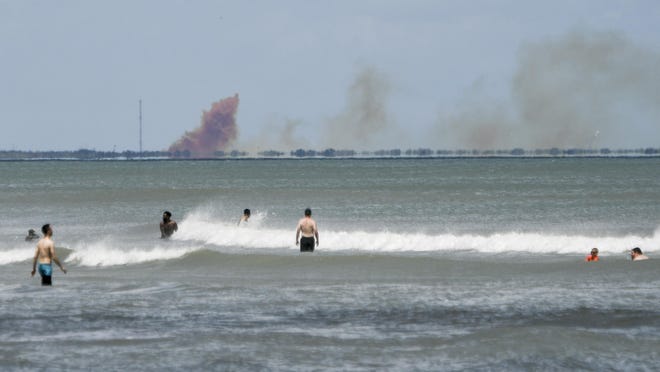 A cloud of orange smoke rises over nearby Cape Canaveral Air Force Station as seen from Cocoa Beach, Fla., Saturday, April 20, 2019. SpaceX reported an anomaly during test firing of their Dragon 2 capsule at their LZ-1 landing site.