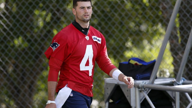 New England Patriots quarterback Jarrett Stidham walks to the field for practice on Friday at Gillette Stadium.