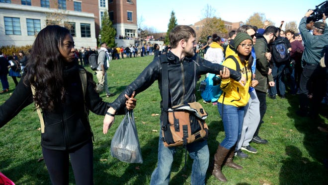 People form a human chain to keep journalists out at the University of Missouri in Columbia on Nov. 9, 2015.