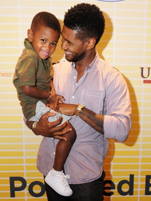 Usher and his son, Usher Raymond V on July 21, 2011 in Atlanta.