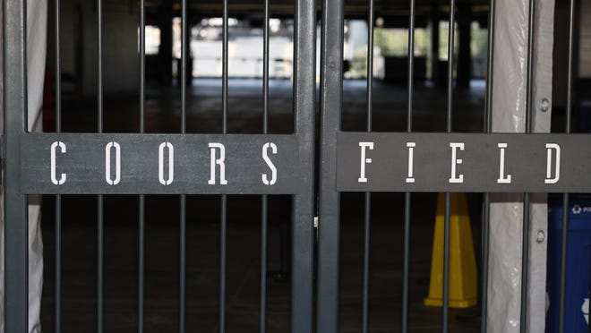 The main gate of Coors Field, home of the Major League Baseball team the Colorado Rockies, is locked early Tuesday, June 23, 2020, in Denver.