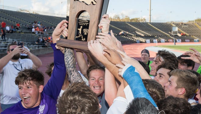 St. Thomas More coach Casey Friend celebrates with his team after winning second-straight state championship.