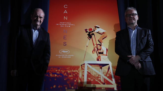 Festival director Thierry Fremaux, right, and festival president Pierre Lescure pose in front of the Cannes International Film Festival poster for the upcoming 72nd edition during a press conference to announce this years line up in Paris, Thursday April 18, 2019. The festival will run from May 14 to May 25, 2019.