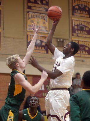 Iona Prep's Josh Alexander shoots over Sean Flynn of Holy Cross during a varsity basketball game at Iona Prep in New Rochelle Dec. 15, 2016. Iona Prep defeated Holy Cross 67-57.